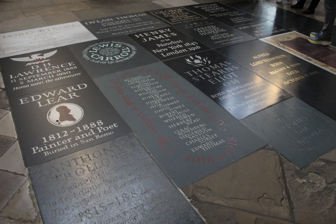 Memorial floorstones in Poets' Corner, Westminster Abbey, photographed in November 2022. Ted Hughes's stone is at the lower right. The Tolkien memorial will be set into a pillar in the same transept
